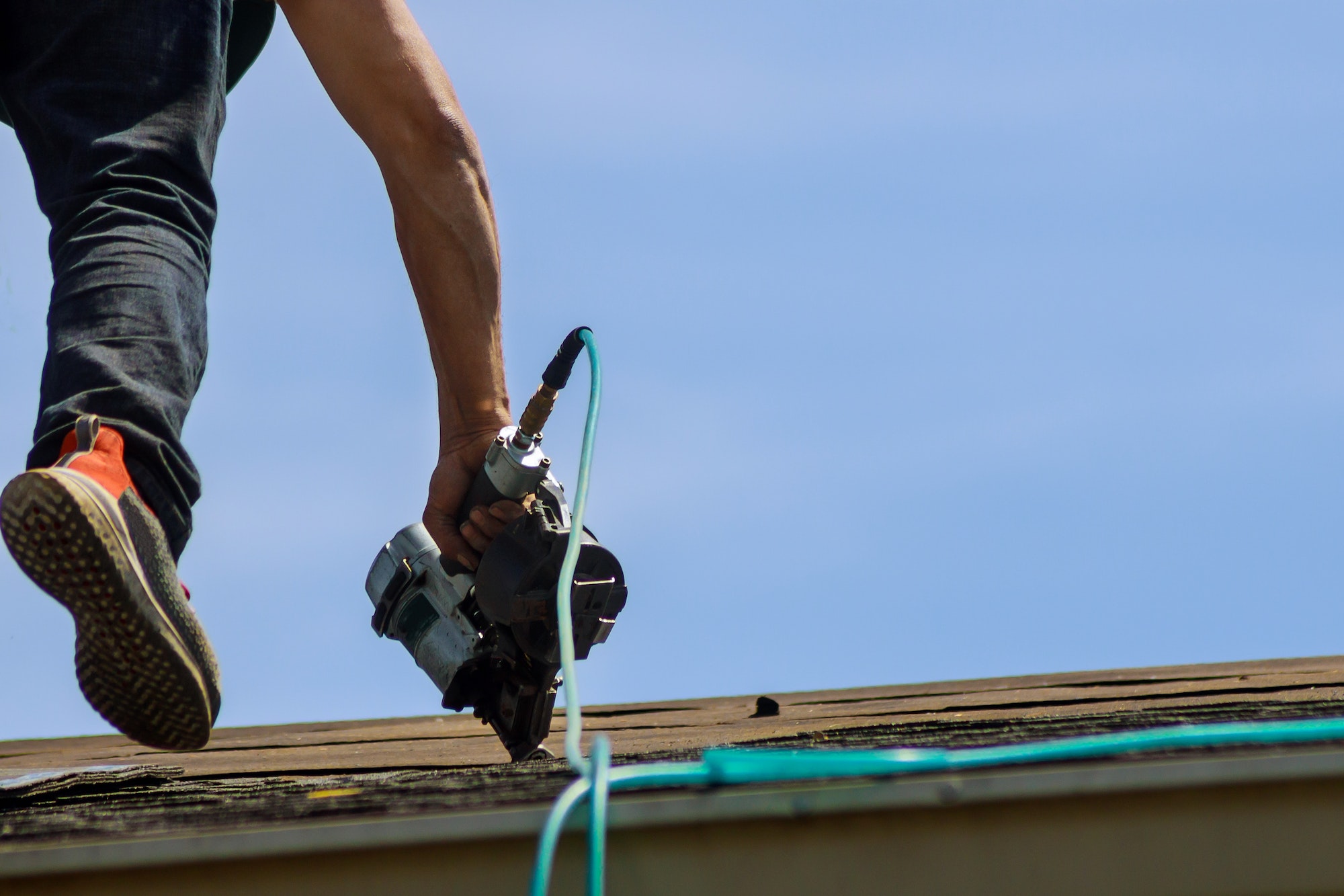 Roofers working on replacing the house installed new shingles